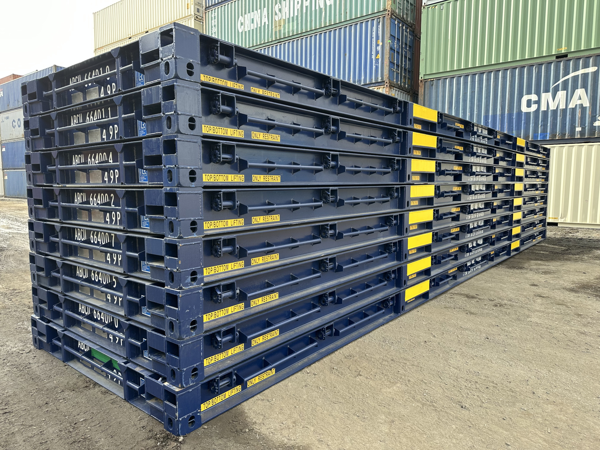 A stack of deep blue 40ft platform containers 8 heigh.